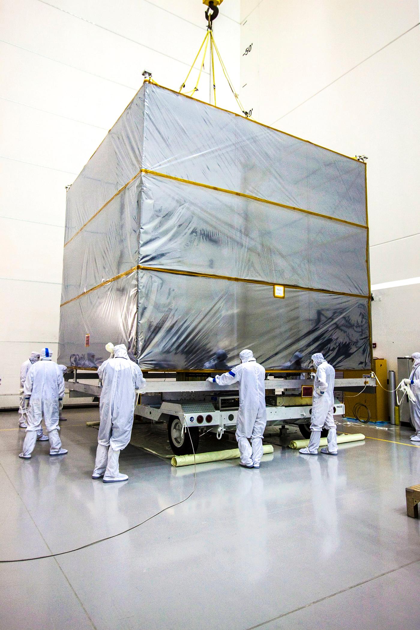 At Astrotech's Hazardous Processing Facility in Titusville, Fla., technicians use an overhead crane to lift the cover... At Astrotech's Hazardous Processing Facility in Titusville, Fla., technicians use an overhead crane to lift the cover...