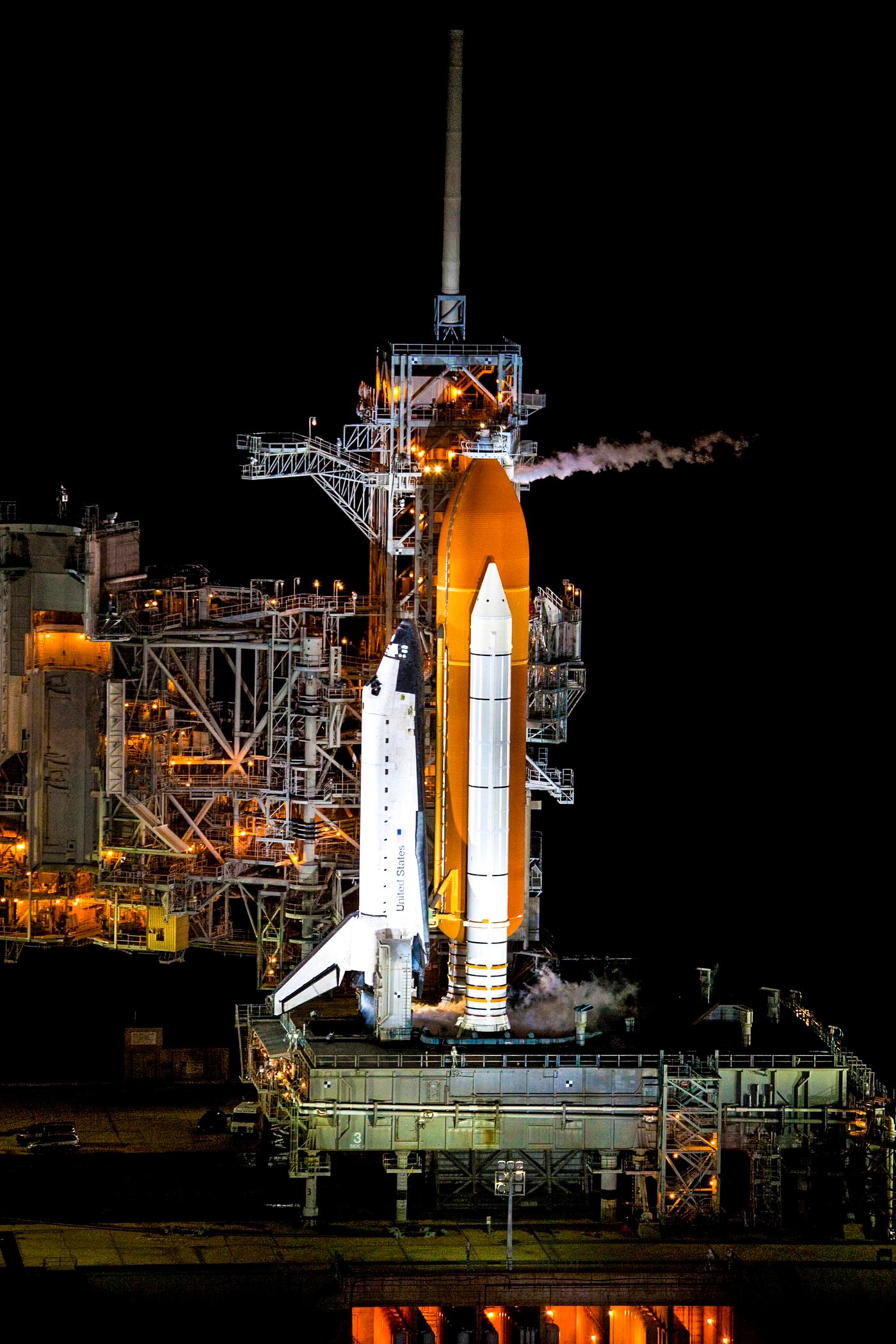 Space shuttle Atlantis, attached to its bright-orange external fuel tank and twin solid rocket boosters on Launch Pad 39A at... Space shuttle Atlantis, attached to its bright-orange external fuel tank and twin solid rocket boosters on Launch Pad 39A at...