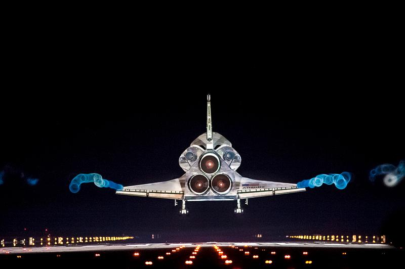 Aircraft in the runway Vapor trails follow space shuttle Atlantis as it approaches Runway 15 on the Shuttle Landing Facility at NASA's Kennedy Space…