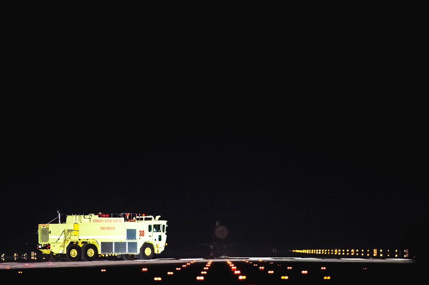 A NASA Fire Rescue truck, which is part of the landing convoy at NASA's Kennedy Space Center in Florida, heads out... A NASA Fire Rescue truck, which is part of the landing convoy at NASA's Kennedy Space Center in Florida, heads out...