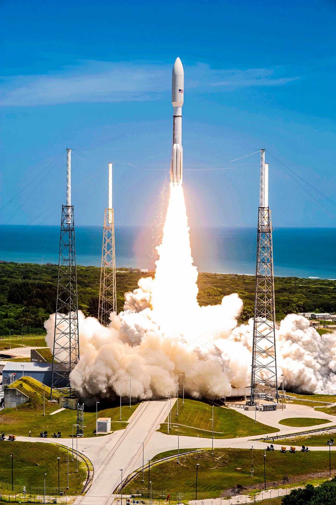 Rising from fire and smoke, NASA's Juno planetary probe, enclosed in its payload fairing, launches atop a United Launch... Rising from fire and smoke, NASA's Juno planetary probe, enclosed in its payload fairing, launches atop a United Launch...