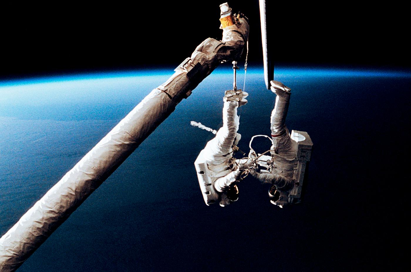 Astronaut Mark C. Lee (right) floats freely as he continues to test the new Simplified Aid for EVA Rescue (SAFER) system... Astronaut Mark C. Lee (right) floats freely as he continues to test the new Simplified Aid for EVA Rescue (SAFER) system...