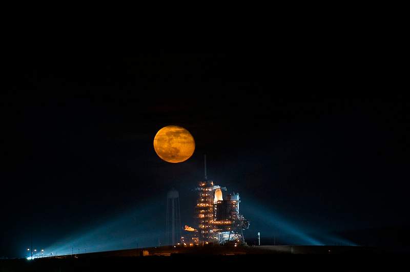 The Space Shuttle Endeavour The moon is seen rising behind the Space Shuttle Endeavour on pad 39A. Original from NASA. Digitally enhanced by rawpixel.