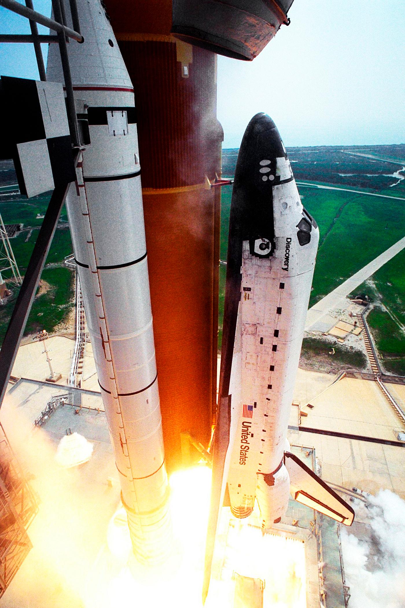 Blasting through the hazy late morning sky, the Space Shuttle Discovery soars from Launch Pad 39A on Aug. 7. Original from... Blasting through the hazy late morning sky, the Space Shuttle Discovery soars from Launch Pad 39A on Aug. 7. Original from...