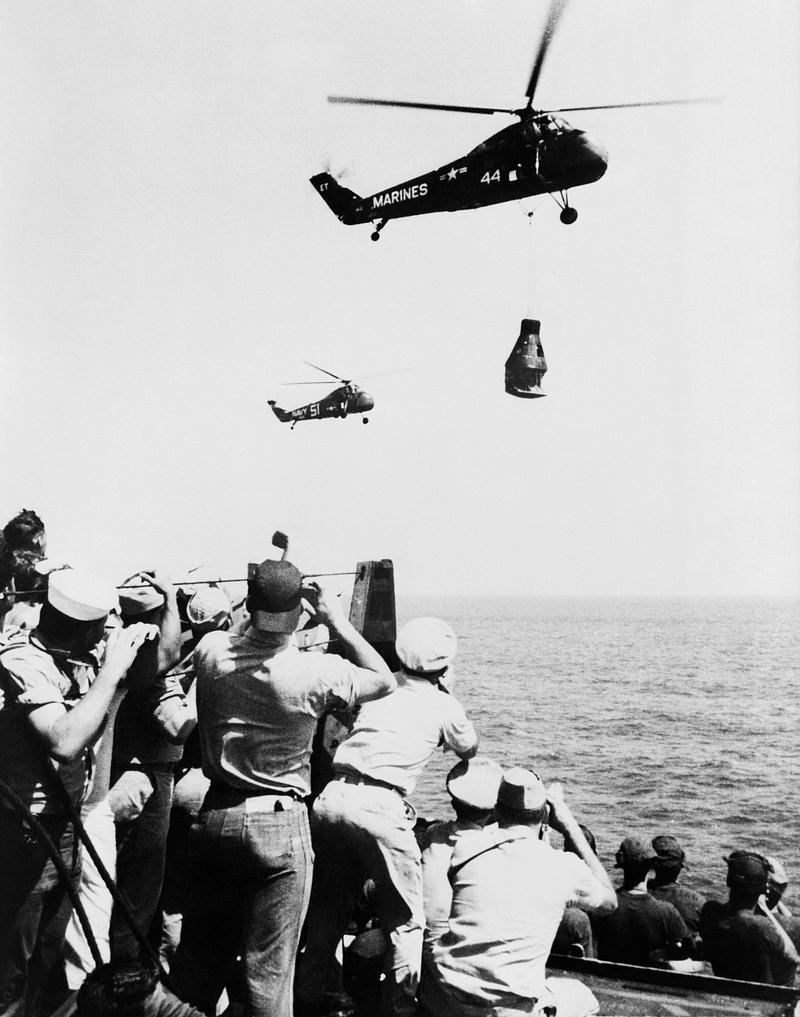 The U.S. Navy Carrier Champlain Crew members of the U.S. Navy Carrier Champlain cheer and take pictures of the arrival of the first Project Mercury pilot.…