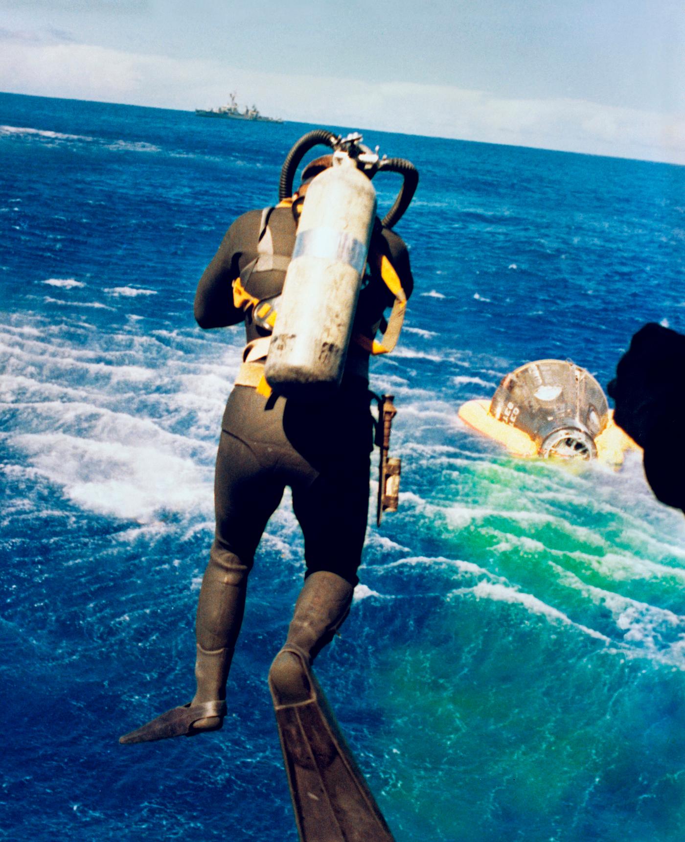 Frogman dives into the water to aid the recovery of Gemini 5. Original from NASA. Digitally enhanced by rawpixel. Frogman dives into the water to aid the recovery of Gemini 5. Original from NASA. Digitally enhanced by rawpixel.