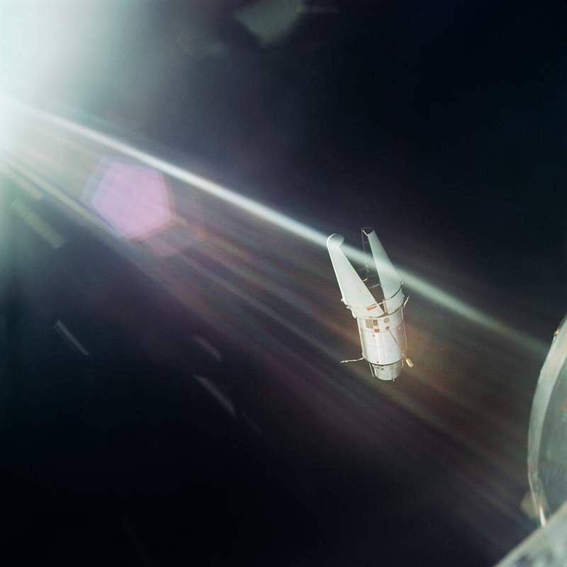 The Augmented Target Docking Adapter is photographed against the background of the blackness of space from the Gemini-9…