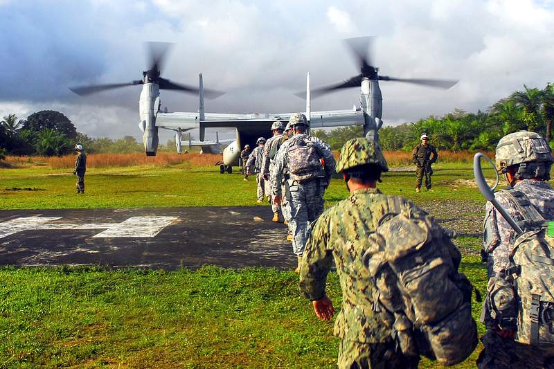 Military soldiers boarding on aircraft for mission. A healthcare provider donning a pair of green latex gloves in order to…