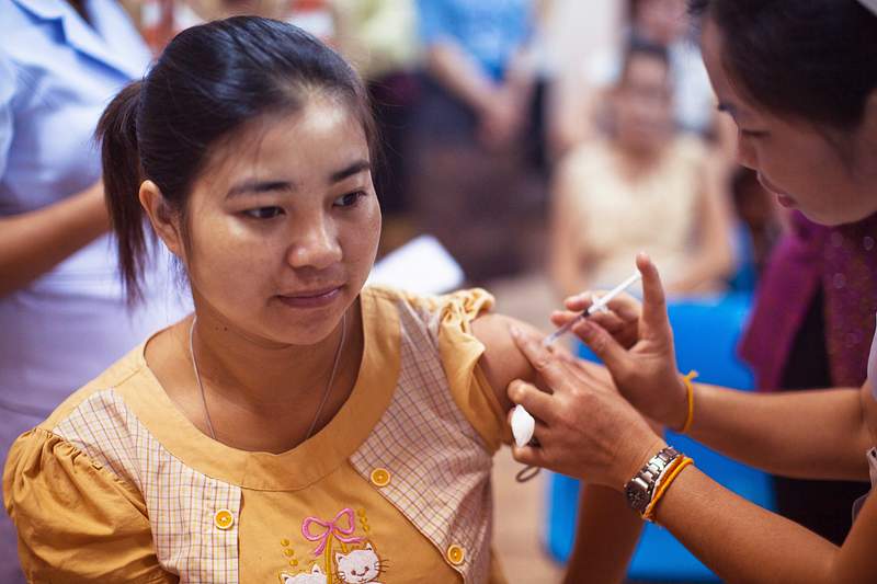 A woman receiving an influenza vaccination at the Maternal and Child Hospital in Vientiane, Laos. Original image sourced from…