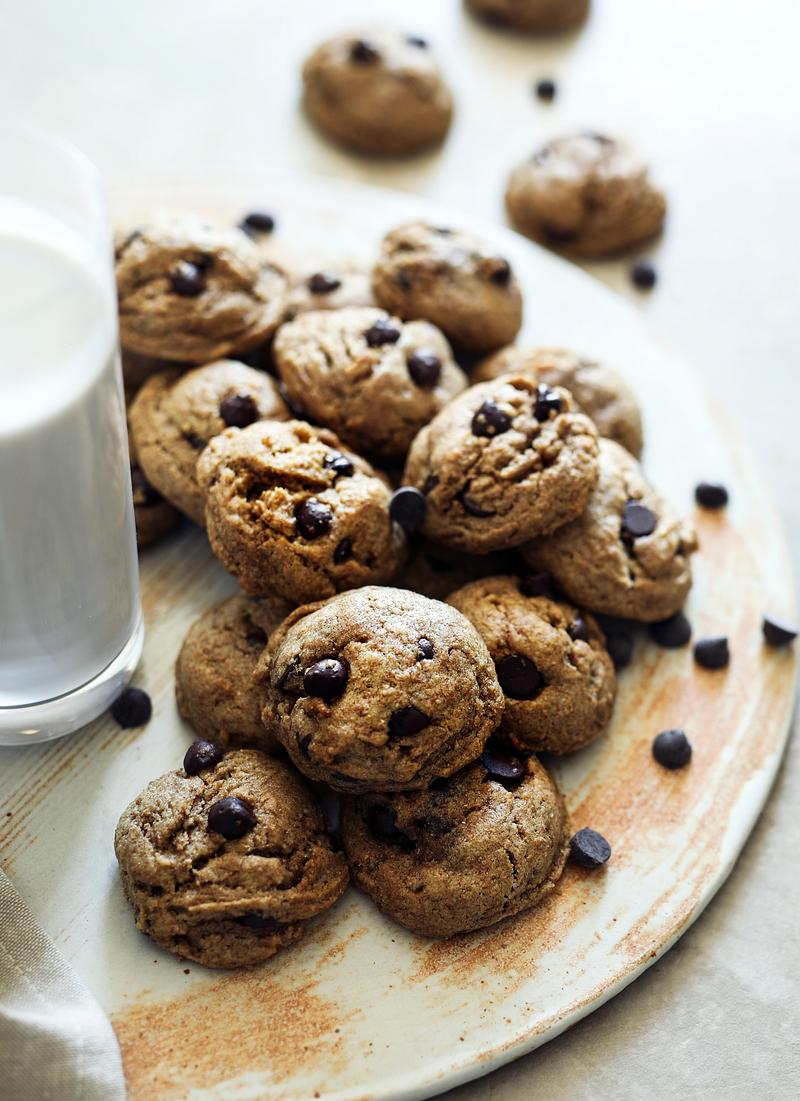 A mouthwatering close-up of vegan chocolate chip cookies, with gooey chocolate chips and a perfectly golden-brown exterior