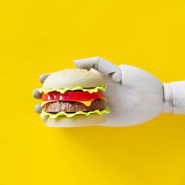 Robot hand holing a hamburger 