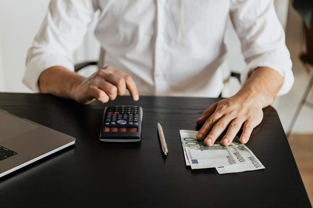 Man calculating his savings during the COVID-19 pandemic