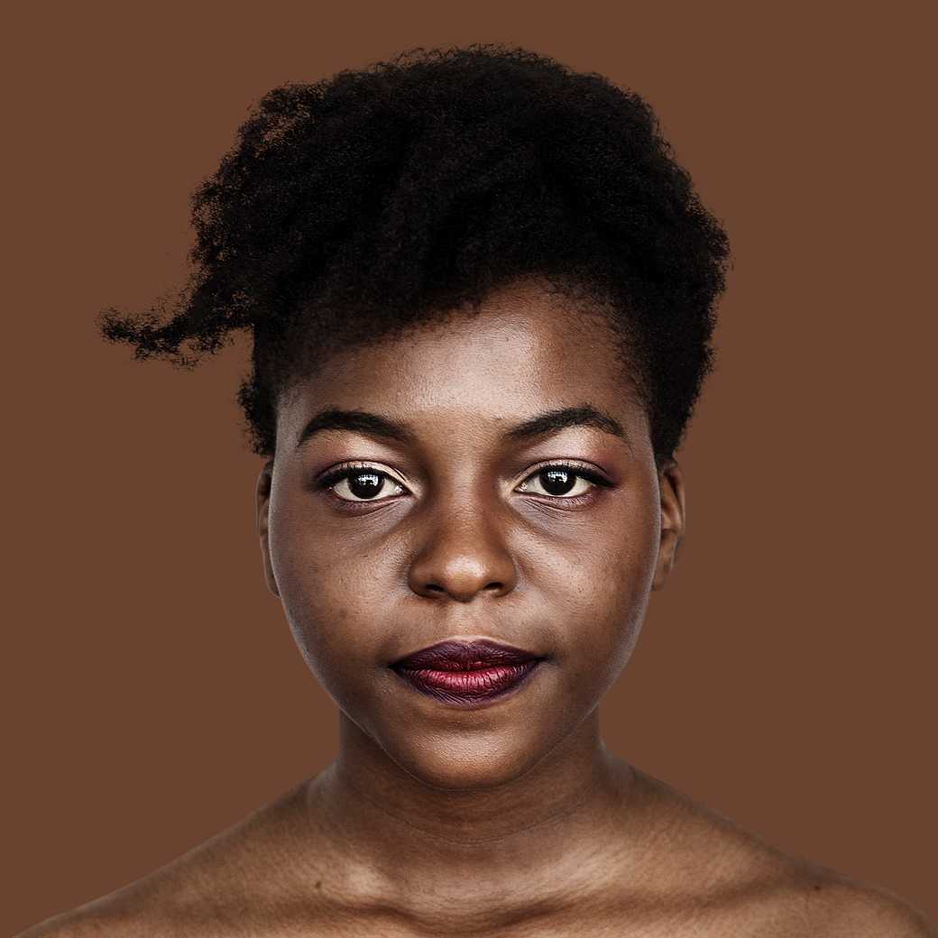 Portrait of an African woman Portrait of an African woman - adult, african, alone, closeup, expression, face, faces, focus, isolated, isolated on white…