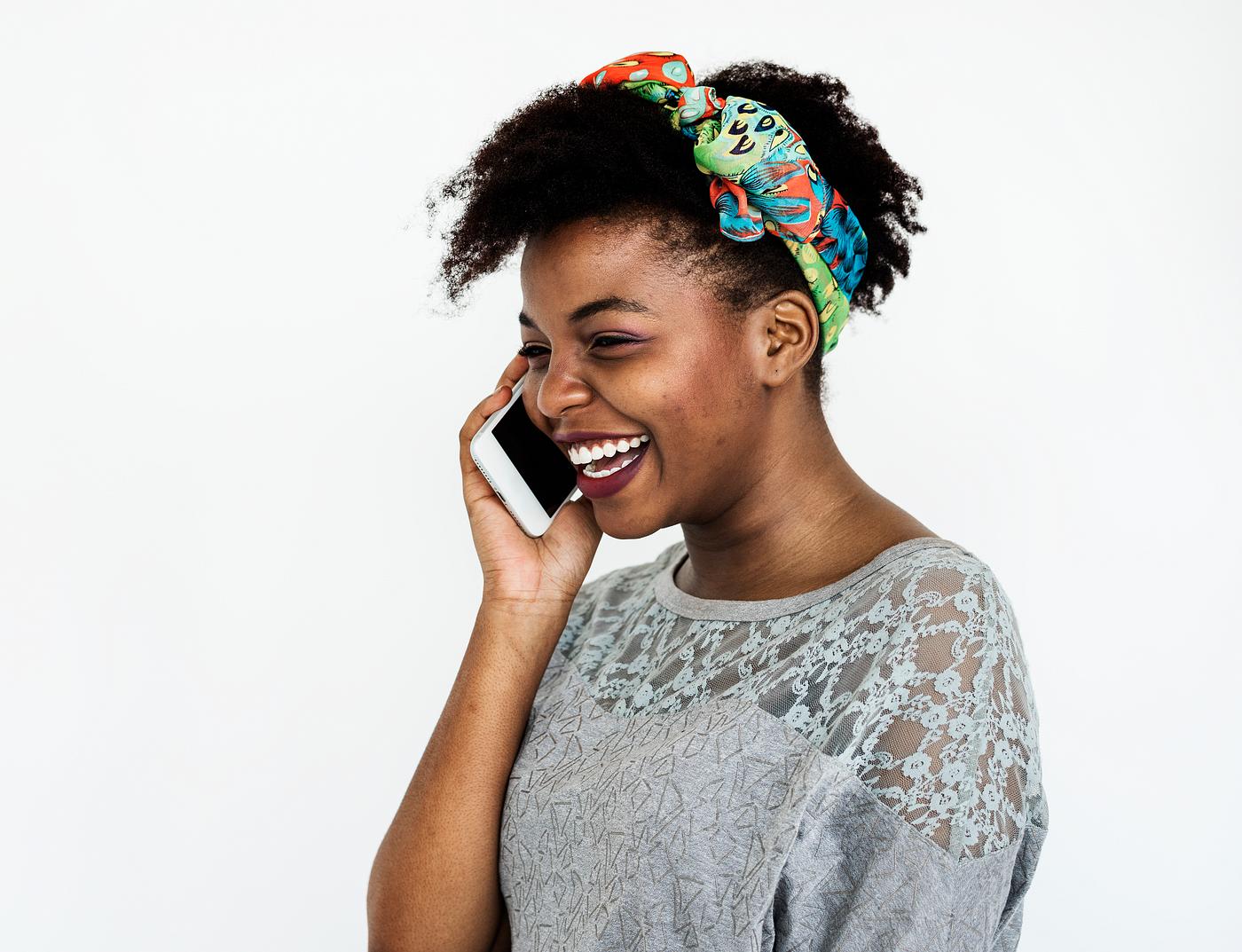 Portrait of an African woman on the phone - mobile phone, african, adult, alone, calling, cheerful, closeup, connected,... Portrait of an African woman on the phone - mobile phone, african, adult, alone, calling, cheerful, closeup, connected,...