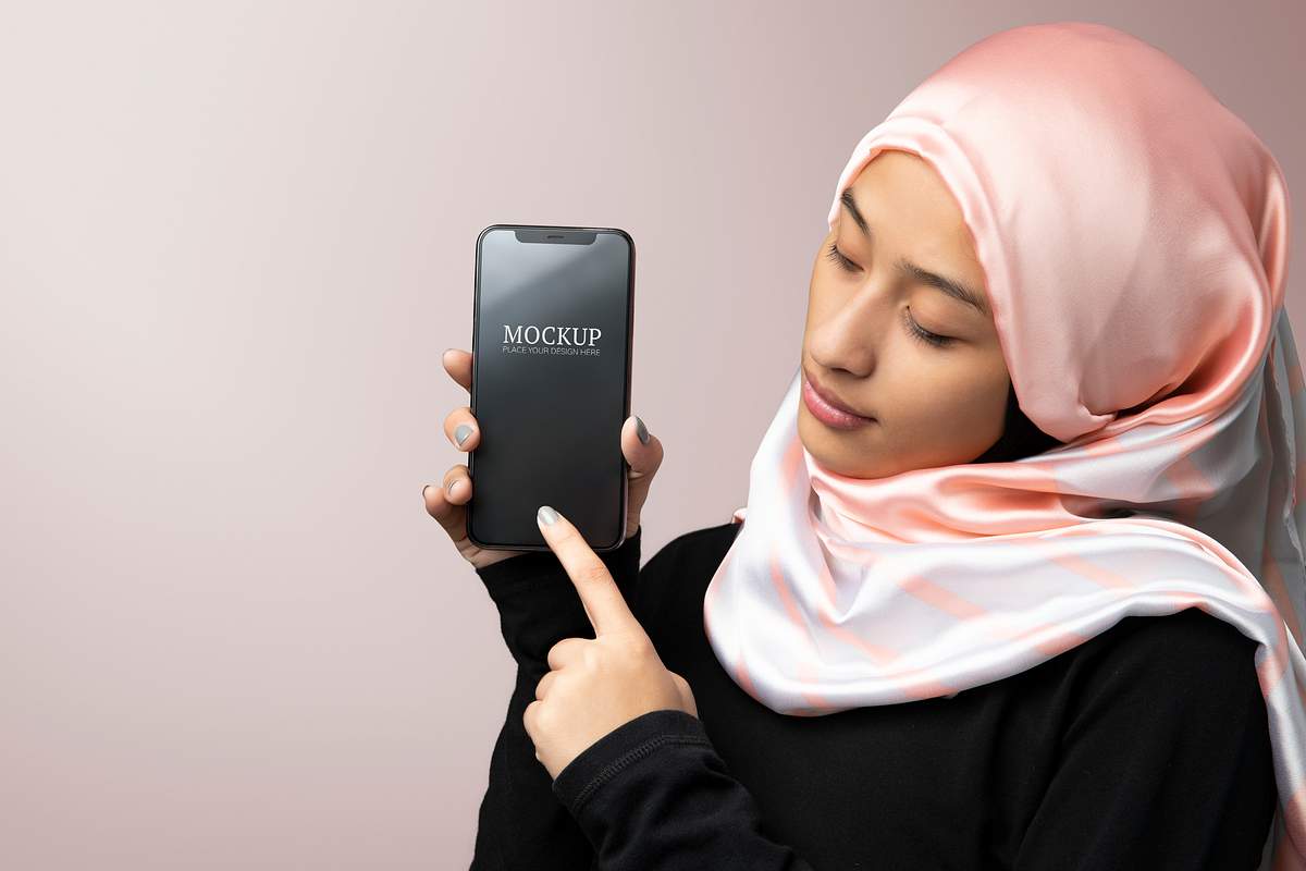 Download Woman Wearing Hijab Holding A Mobile Phone Mockup Royalty Free Stock Photo High Resolution Image