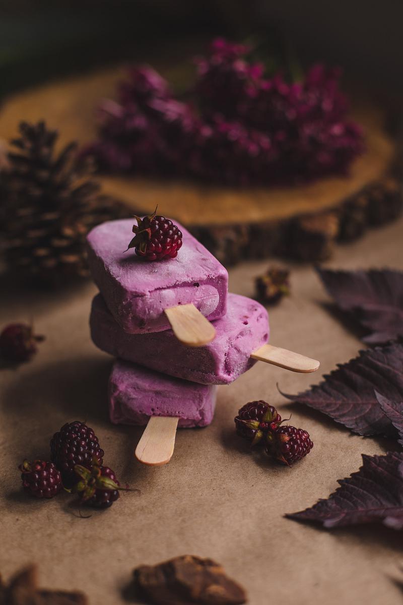 Pink loganberry popsicles on a table with… | Free public domain photo Pink loganberry popsicles on a table with dried leaves and pinecones. Original public domain image from Wikimedia Commons
